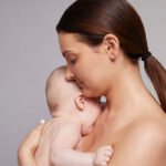 Mother holding her sleeping baby close to her chest